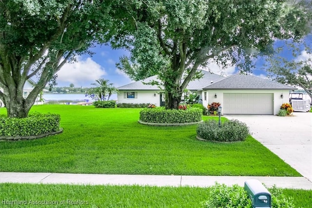 130 Deanna Dr, Lake Placid, FL 33852 - ranch-style home featuring a front yard, a garage, a water view, and concrete driveway