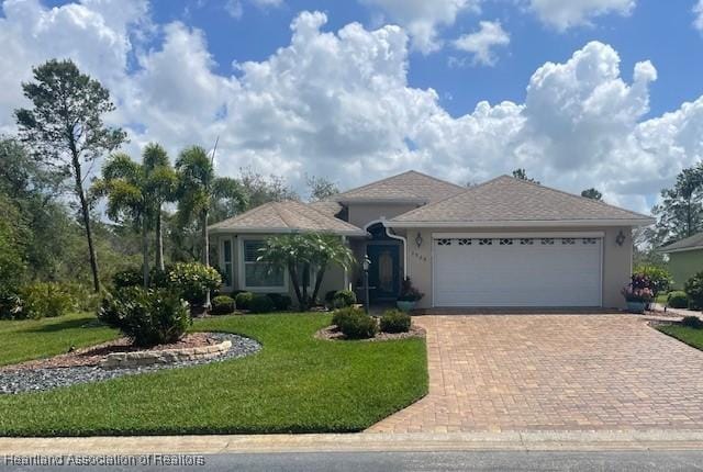 3929 Puma Dr, Avon Park, FL 33825 - single story home featuring a garage, decorative driveway, a front lawn, and stucco siding