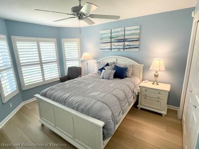 3929 Puma Dr, Avon Park, FL 33825 - bedroom with wood finished floors, a ceiling fan, and a closet