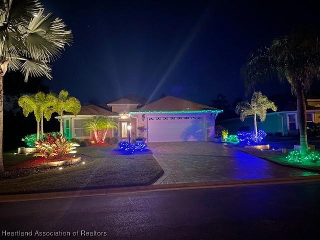 3929 Puma Dr, Avon Park, FL 33825 - view of front of property with decorative driveway and an attached garage