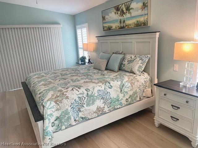 3929 Puma Dr, Avon Park, FL 33825 - bedroom featuring light wood-type flooring and multiple windows