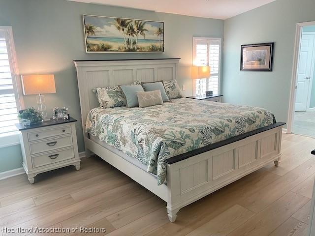 3929 Puma Dr, Avon Park, FL 33825 - bedroom featuring light wood-style flooring and baseboards