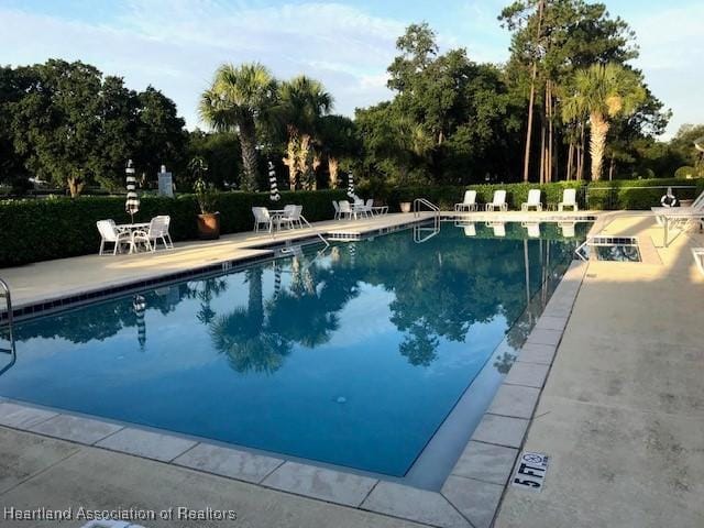3929 Puma Dr, Avon Park, FL 33825 - community pool with a patio area and view of scattered trees