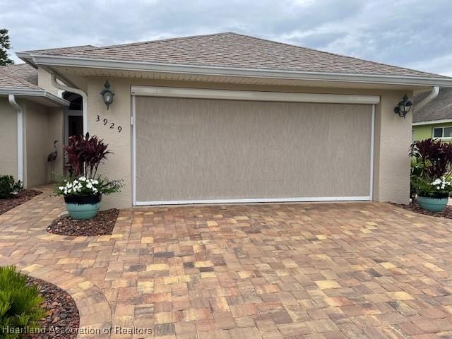 3929 Puma Dr, Avon Park, FL 33825 - garage featuring decorative driveway