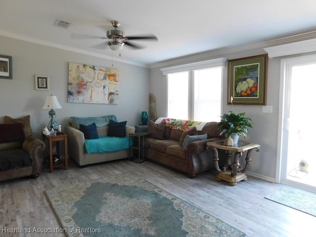 living room with ornamental molding, hardwood / wood-style floors, and ceiling fan