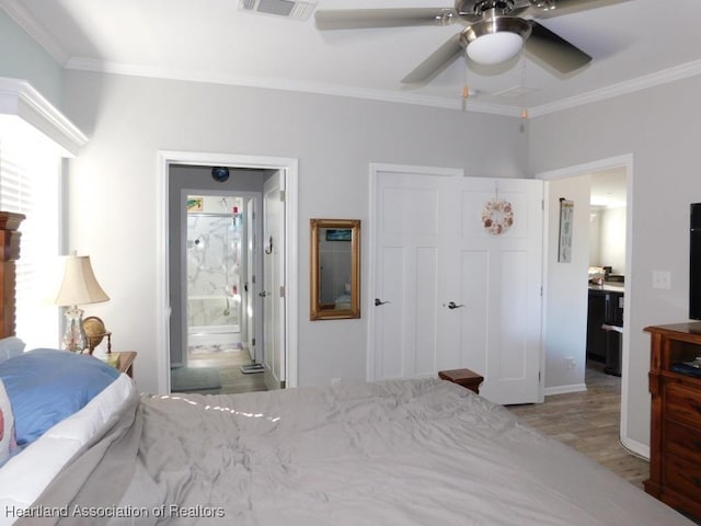 bedroom featuring crown molding, ceiling fan, connected bathroom, a closet, and light wood-type flooring