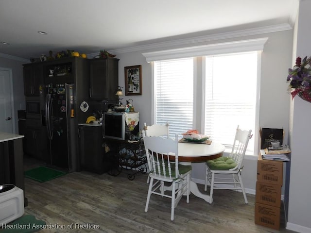 dining room with hardwood / wood-style flooring and ornamental molding