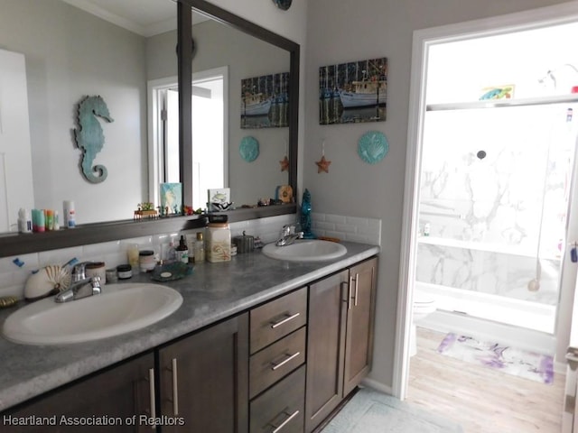 bathroom with vanity, ornamental molding, and toilet