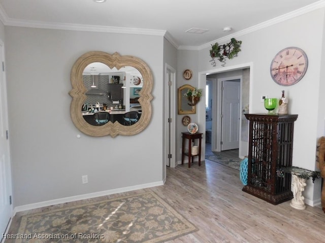 interior space with hardwood / wood-style floors and ornamental molding