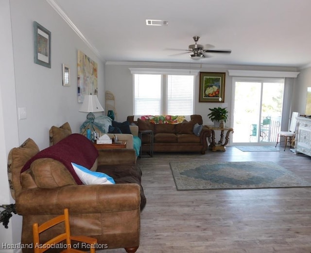 living room with crown molding, ceiling fan, and hardwood / wood-style flooring