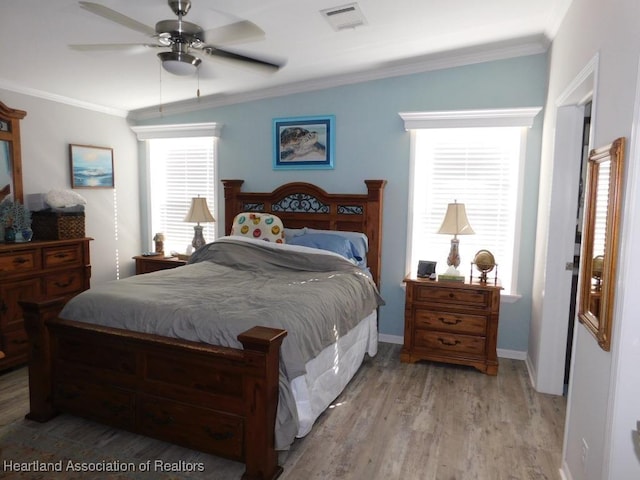 bedroom featuring ceiling fan, ornamental molding, and light hardwood / wood-style flooring