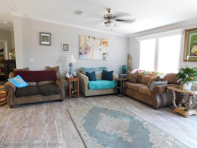 living room featuring ornamental molding, hardwood / wood-style floors, and ceiling fan