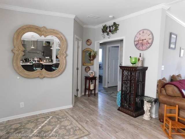 interior space with ornamental molding and wood-type flooring