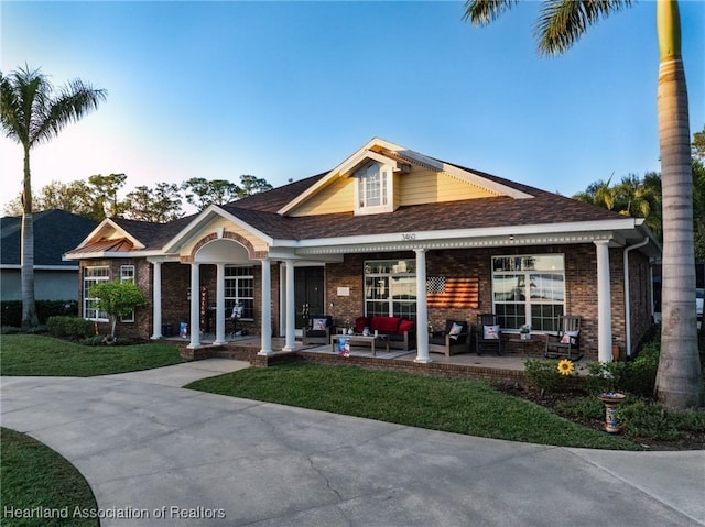 view of front of home with outdoor lounge area and a front lawn