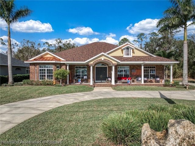 view of front of property featuring a porch and a front lawn