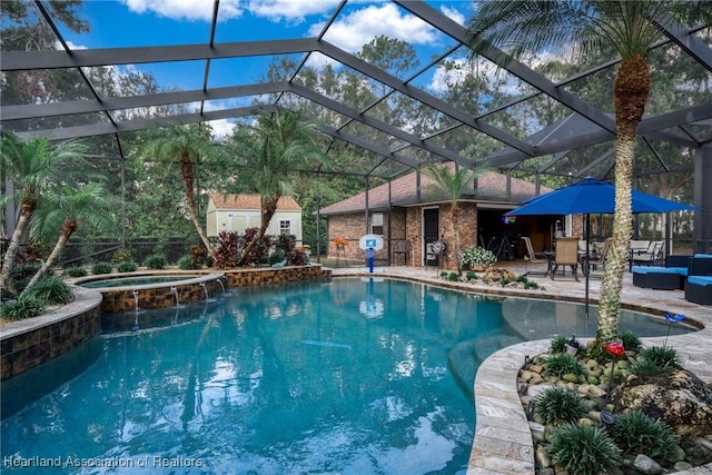 view of pool featuring an in ground hot tub, a patio, and glass enclosure