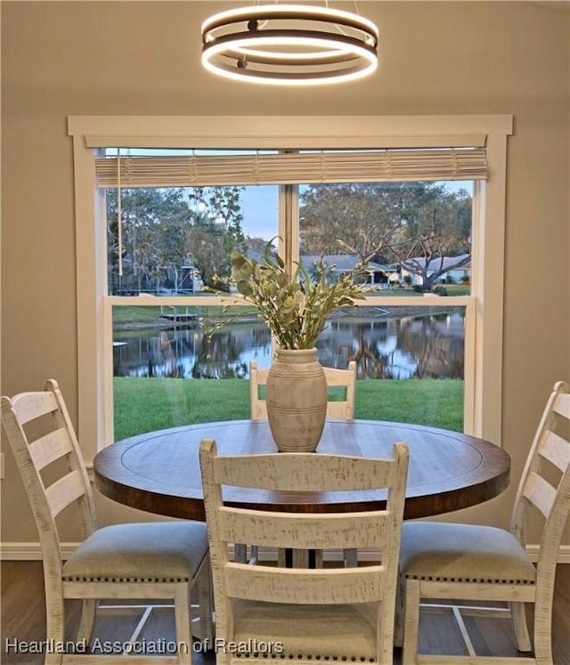 dining room with a water view and a healthy amount of sunlight