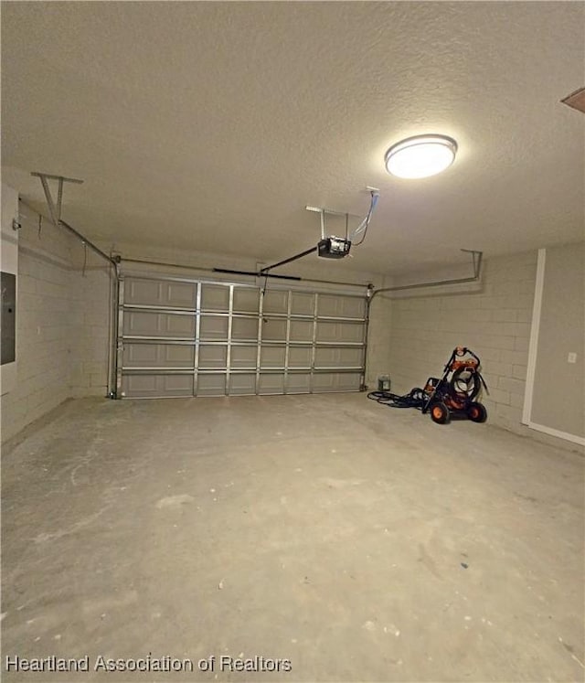 garage featuring electric panel and a garage door opener