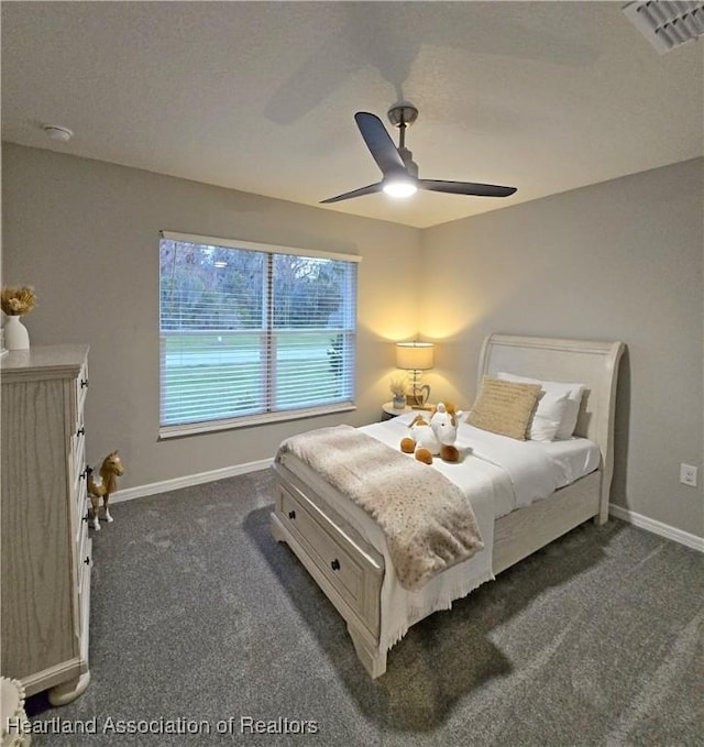 bedroom featuring dark carpet and ceiling fan