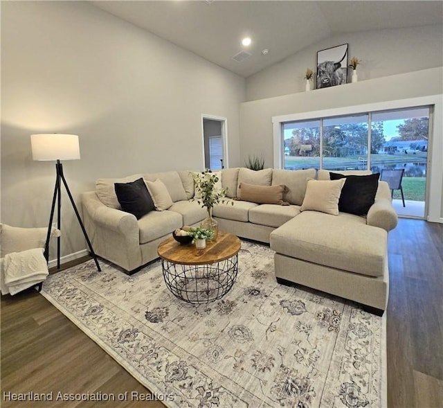 living room featuring hardwood / wood-style flooring and high vaulted ceiling