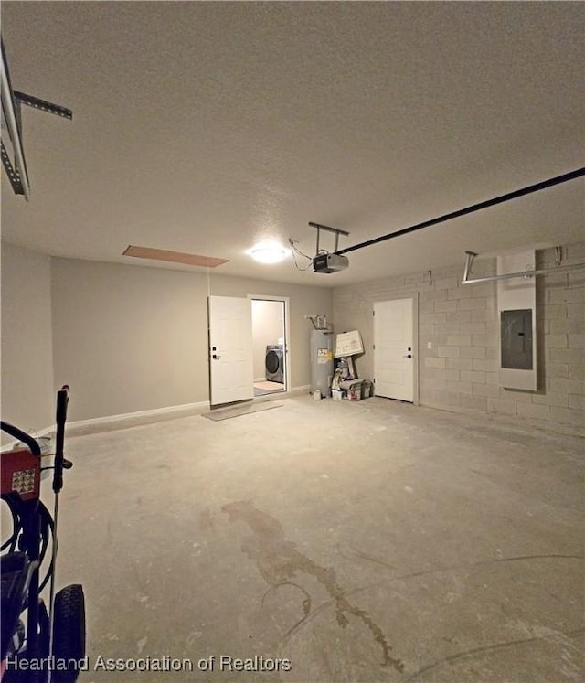 garage featuring electric panel, water heater, a garage door opener, and washer / dryer