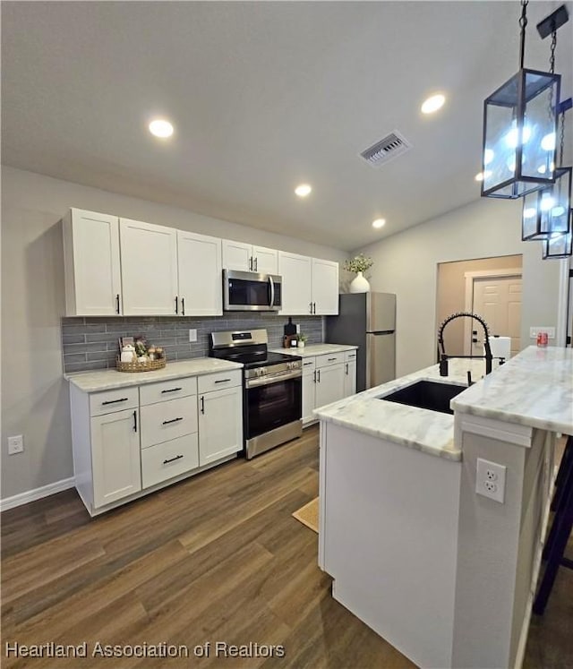 kitchen with pendant lighting, stainless steel appliances, white cabinetry, and sink