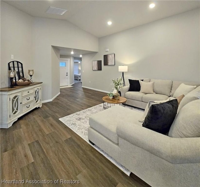 living room with dark hardwood / wood-style flooring and vaulted ceiling