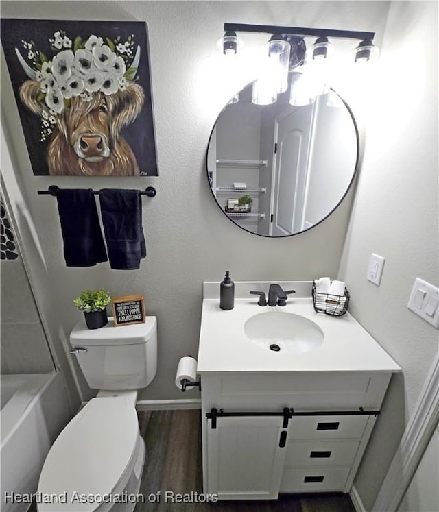 bathroom featuring hardwood / wood-style flooring, vanity, and toilet