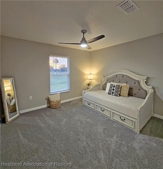 unfurnished bedroom with ceiling fan and dark carpet