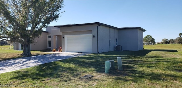 view of front of house with a front yard, a garage, and central air condition unit