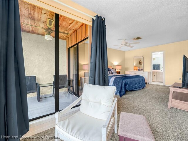 bedroom featuring a textured ceiling, ceiling fan, connected bathroom, carpet flooring, and visible vents