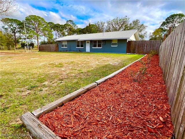 back of property with a lawn