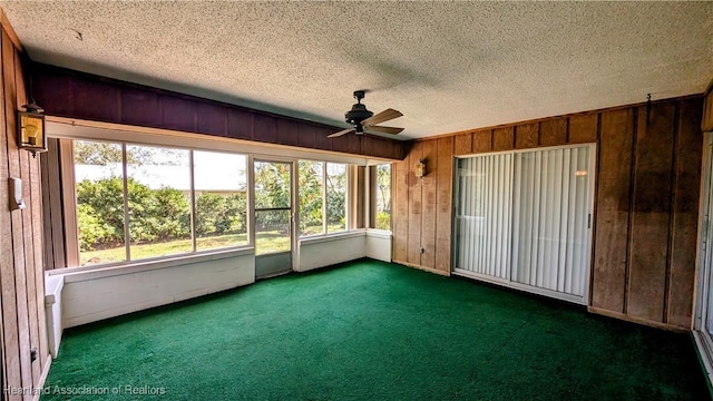 unfurnished sunroom featuring ceiling fan