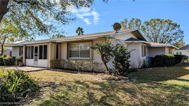 rear view of property with a yard