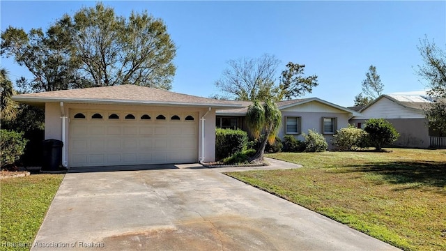 ranch-style home with a front lawn and a garage