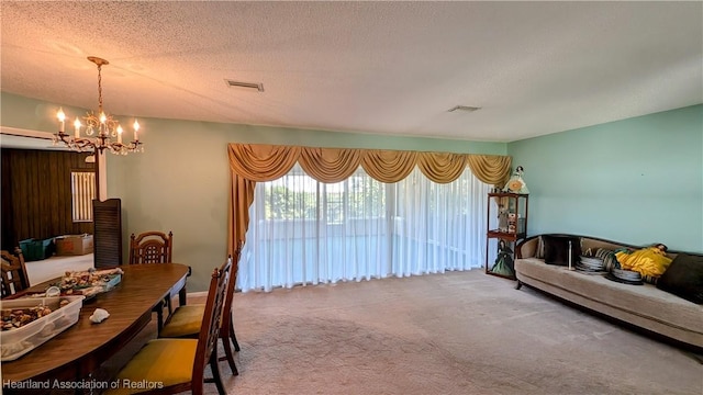 carpeted living room with a textured ceiling and a chandelier