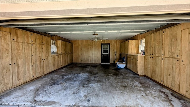 garage featuring wood walls