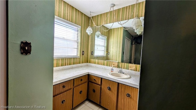 bathroom featuring tile patterned flooring, vanity, and a textured ceiling