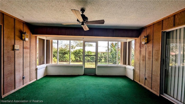 unfurnished sunroom featuring ceiling fan