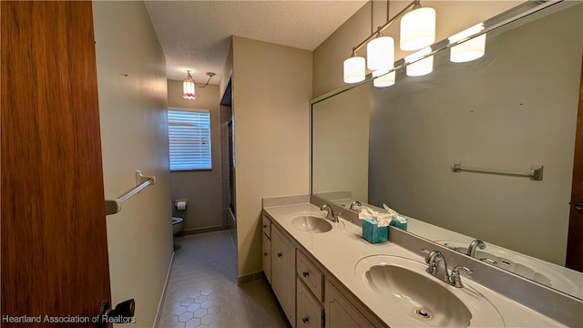 bathroom featuring walk in shower, tile patterned floors, a textured ceiling, toilet, and vanity