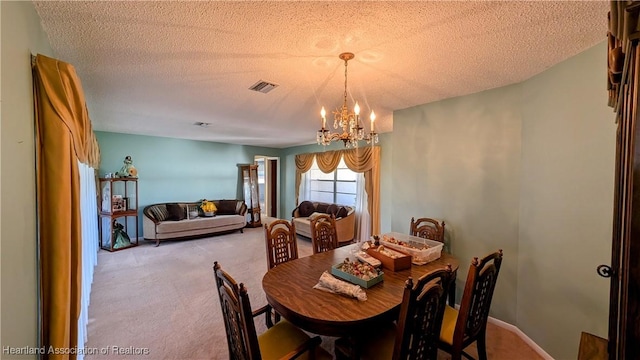 carpeted dining space with a textured ceiling and a chandelier