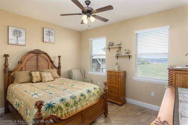 bedroom with baseboards and a ceiling fan