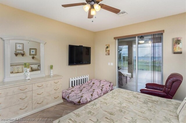 bedroom featuring access to exterior, visible vents, and a ceiling fan