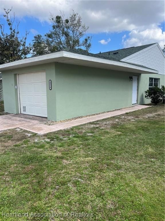 view of home's exterior featuring a garage and a yard