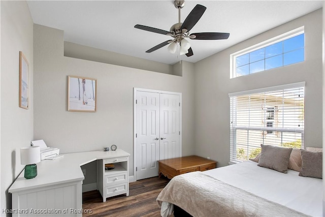 bedroom featuring dark wood-type flooring, a closet, and ceiling fan