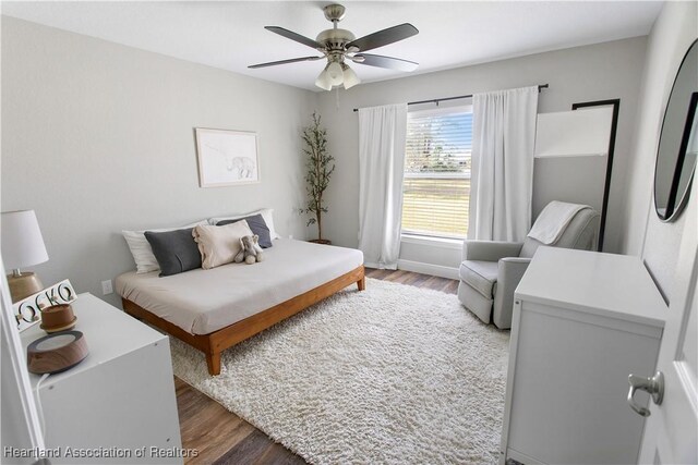 bedroom featuring ceiling fan and dark wood-style flooring