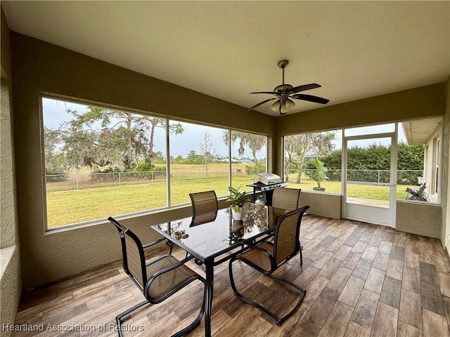 sunroom featuring ceiling fan