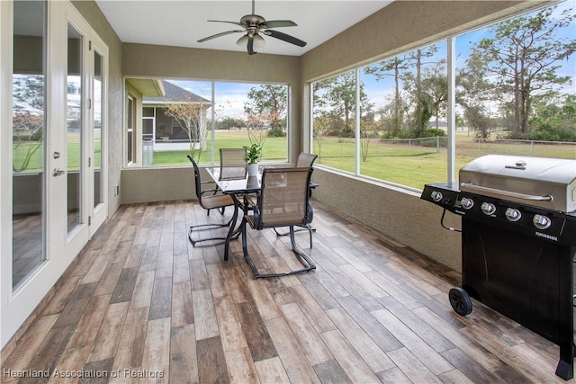 sunroom / solarium with a wealth of natural light and ceiling fan