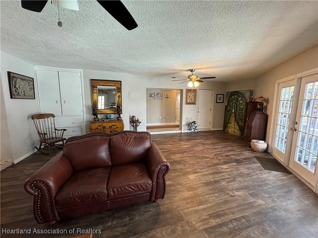 living area with ceiling fan, a textured ceiling, baseboards, and wood finished floors