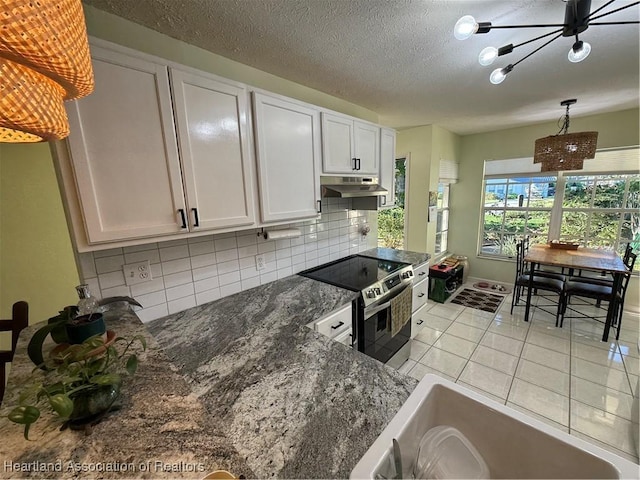 100 Daisy Ln, Lake Placid, FL 33852 - kitchen featuring stainless steel range with electric stovetop, a chandelier, backsplash, under cabinet range hood, and white cabinetry